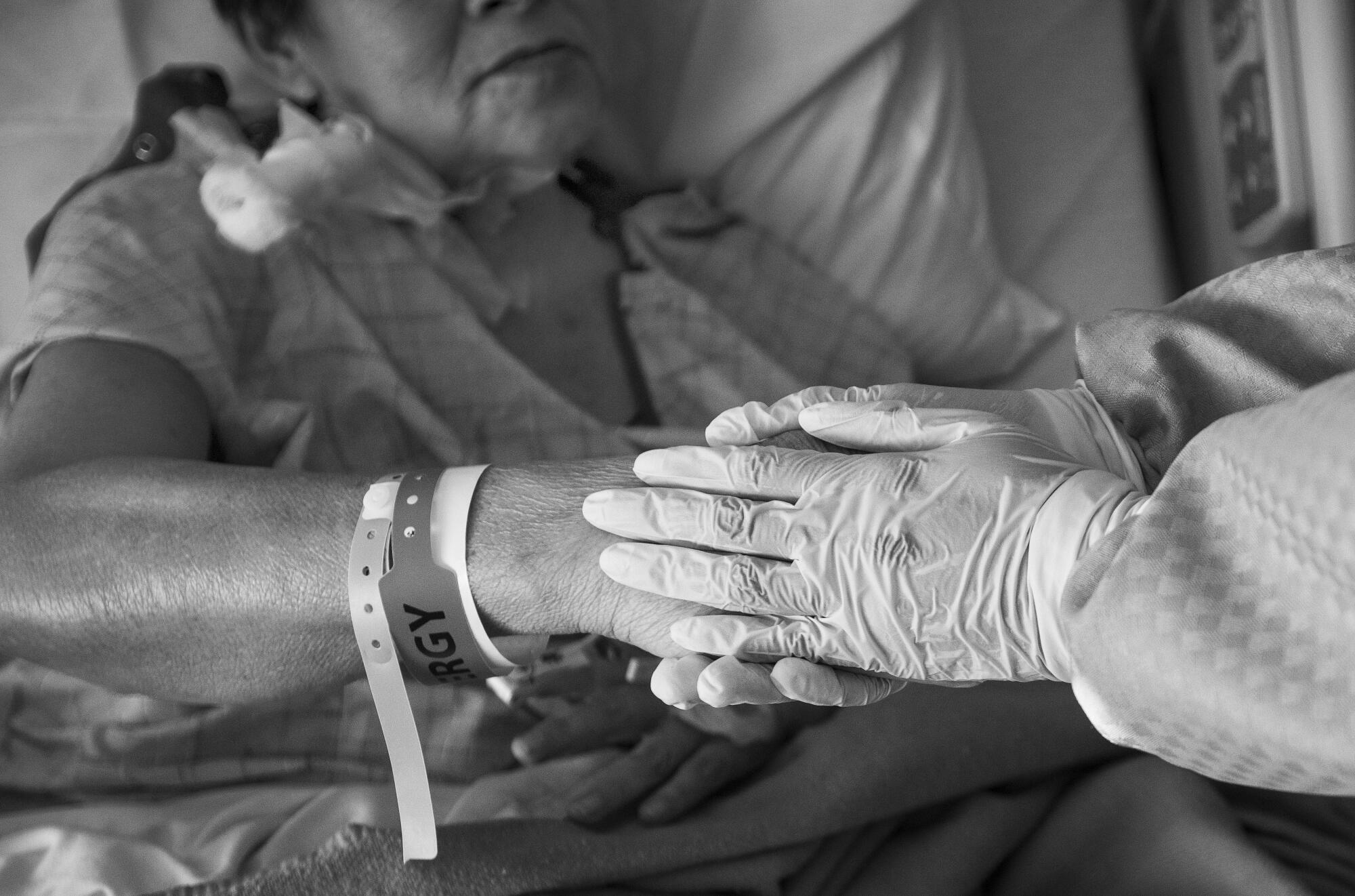 Dr. Maita Kuvhenguhwa holds Maria Cuellar's hand. "Maita" means "Thank you," from her father's first language from Zimbabwe.