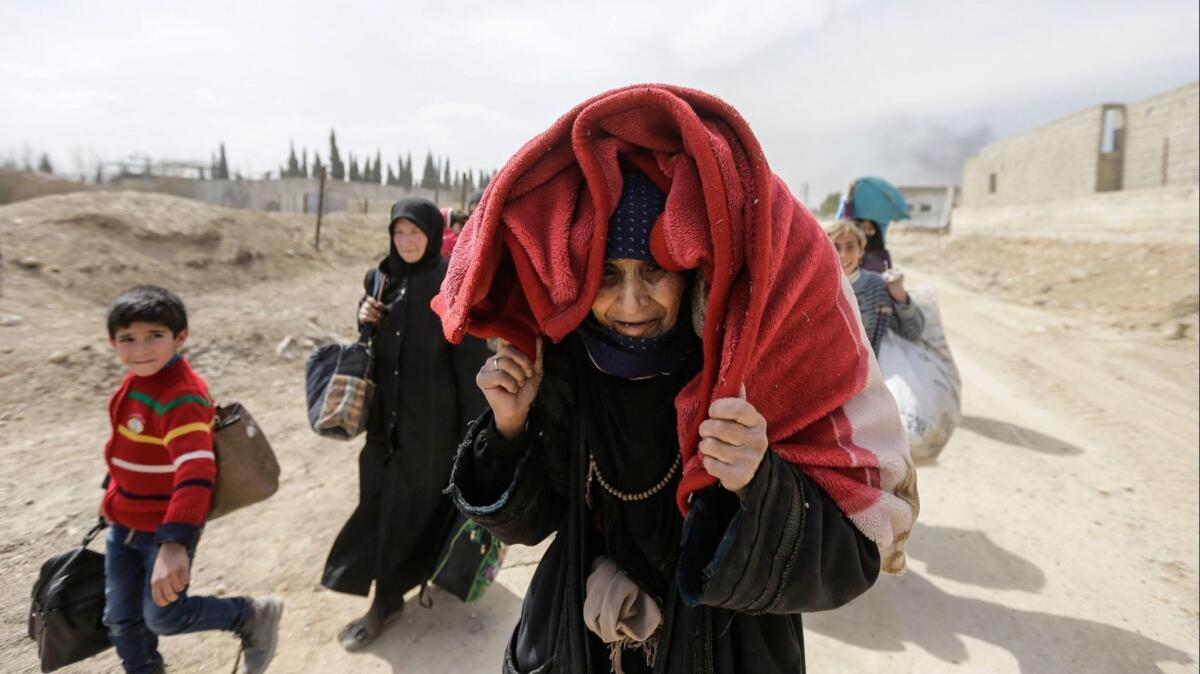 Syrian civilians flee rebel-held eastern Ghouta on the outskirts of Damascus.