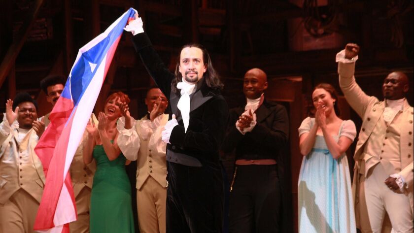 "Hamilton" creator and star Lin-Manuel Miranda, center, with his cast of a benefit production for Puerto Rico hurricane recovery, speaks to the audience at curtain call Friday night in San Juan.