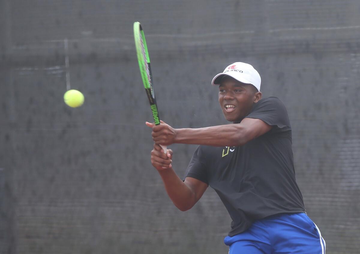 Jean-Baptiste Badon of Sunland plays against Jett Cole of Laguna Beach in the boys' 18-and-under round of 16 singles match at the USTA Southern California Junior Sectional Championships at Costa Mesa Tennis Center on Friday.