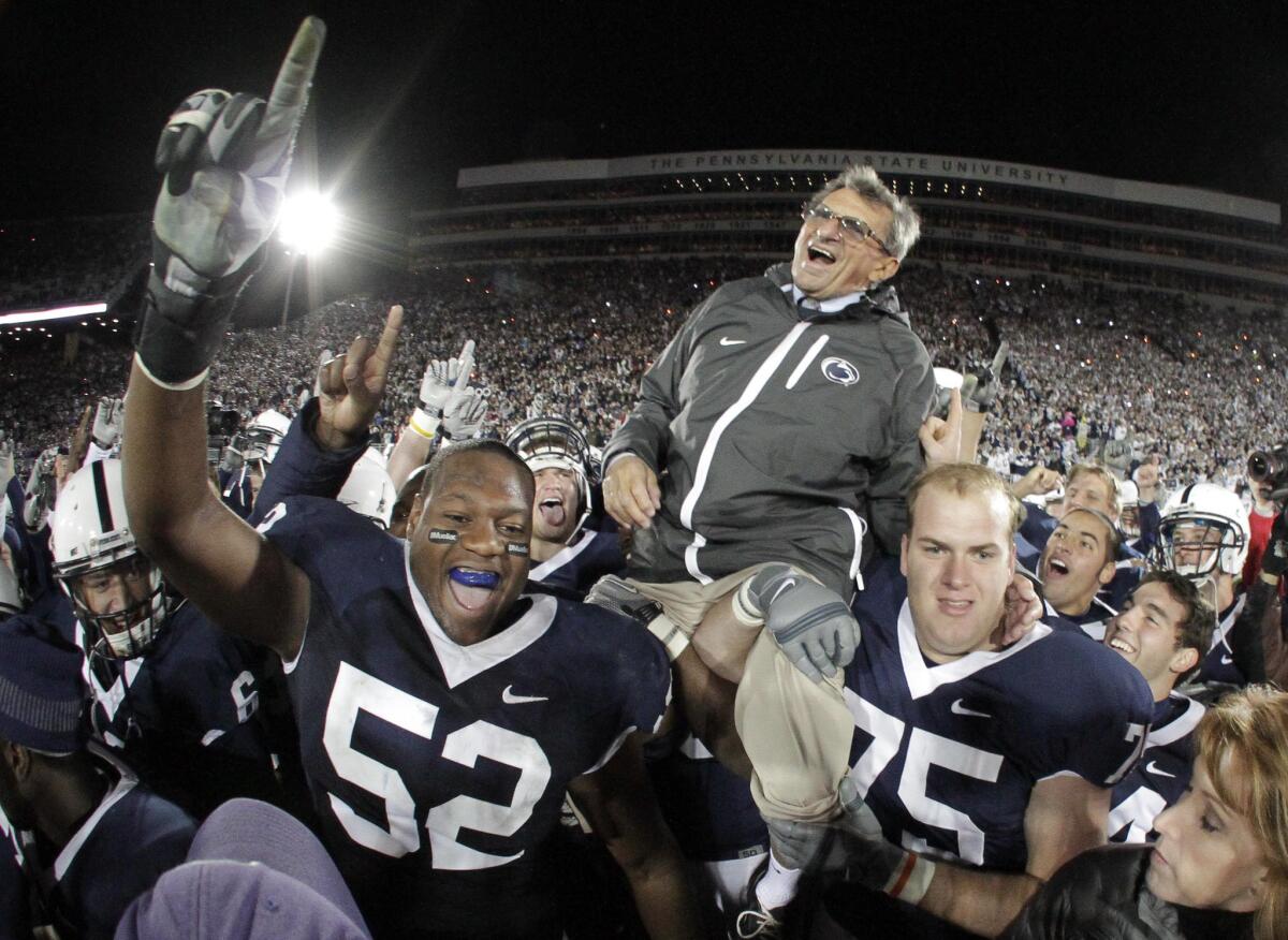 Joe Paterno is carried off the field by Penn State players after getting his 400th collegiate coaching win on Nov. 6, 2010.