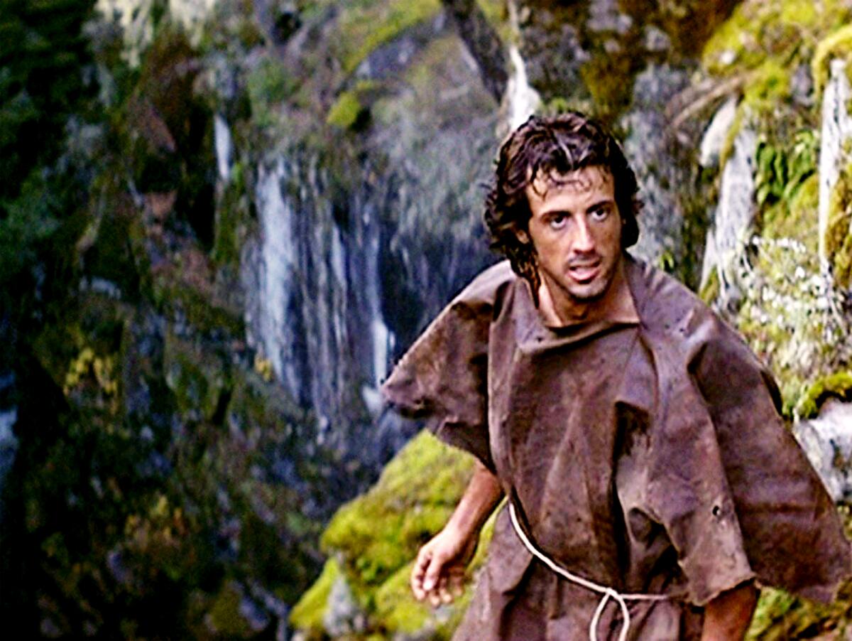 Sylvester Stallone, arsenic John Rambo, stands adjacent a waterfall successful "First Blood."