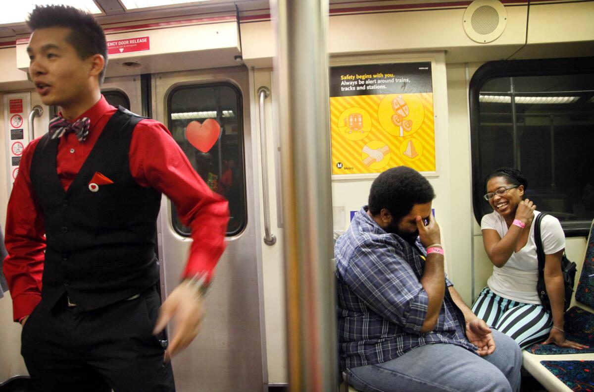 Simon Wong, dressed in red and black and two others ride the red line train Friday during a Valentine's Day speed-dating event.