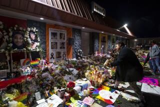 FILE - Kebrina Chirdon lights candles at a memorial outside of Club Q on Nov. 25, 2022, in Colorado Springs, Colo. After the mass shooting last November at the LGBTQ+ nightclub in Colorado Springs that turned a drag queen’s birthday celebration into a massacre, the conservative community was forced to reckon with its reputation for being unwelcoming to gay, lesbian and transgender people. (Parker Seibold/The Gazette via AP, File)