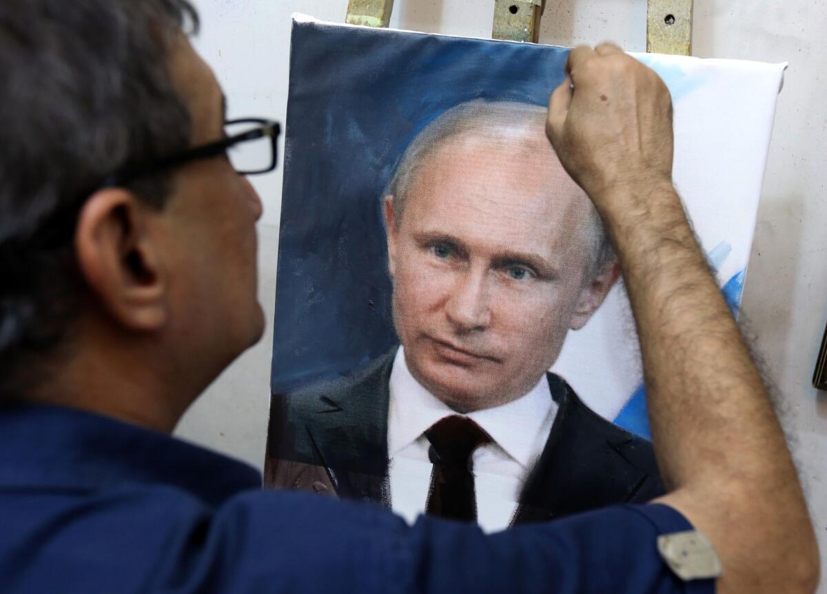 An Iraqi artist touches up a painting of Vladimir Putin in his studio in Baghdad on Oct. 7. Putin's popularity has soared in Iraq since Russia joined the fray in Syria with an aerial campaign and dispatched intelligence officials to Baghdad.