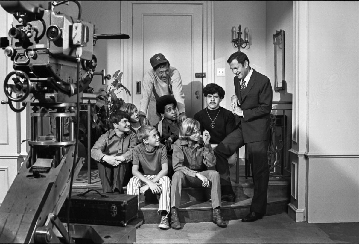 August 1970: Jack Klugman, wearing baseball cap, and Tony Randall play host to "little brother" members of Big Brothers of America during their visit to the Paramount set of "The Odd Couple."