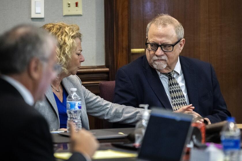 BRUNSWICK, GEORGIA - NOVEMBER 24: Defense attorney Laura Hogue, center, touches the hand of her client Greg McMichael, right, while they wait for the jury to come into to the courtroom during deliberations in the trial deliberations in the trial of Greg McMichel and his son, Travis McMichael, and a neighbor, William "Roddie" Bryan in the Glynn County Courthouse on November 24, 2021 in Brunswick, Georgia. Greg McMichael, his son Travis McMichael, and a neighbor, William "Roddie" Bryan are charged with the February, 2020 fatal shooting of 25-year-old Ahmaud Arbery. (Photo by Stephen B. Morton-Pool/Getty Images)