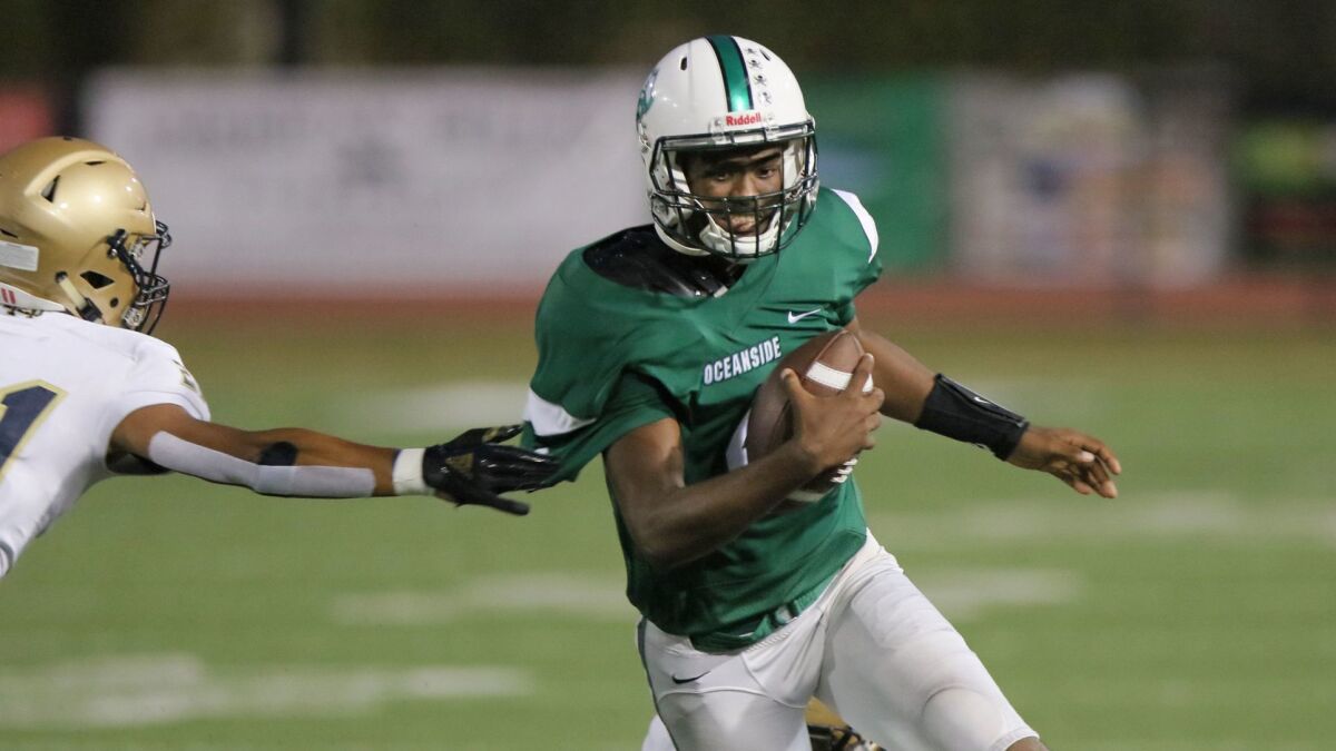 Oceanside quarterback Kyrin Beachem (shown in an earlier game) sparked the Pirates to a win over rival El Camino on Friday.