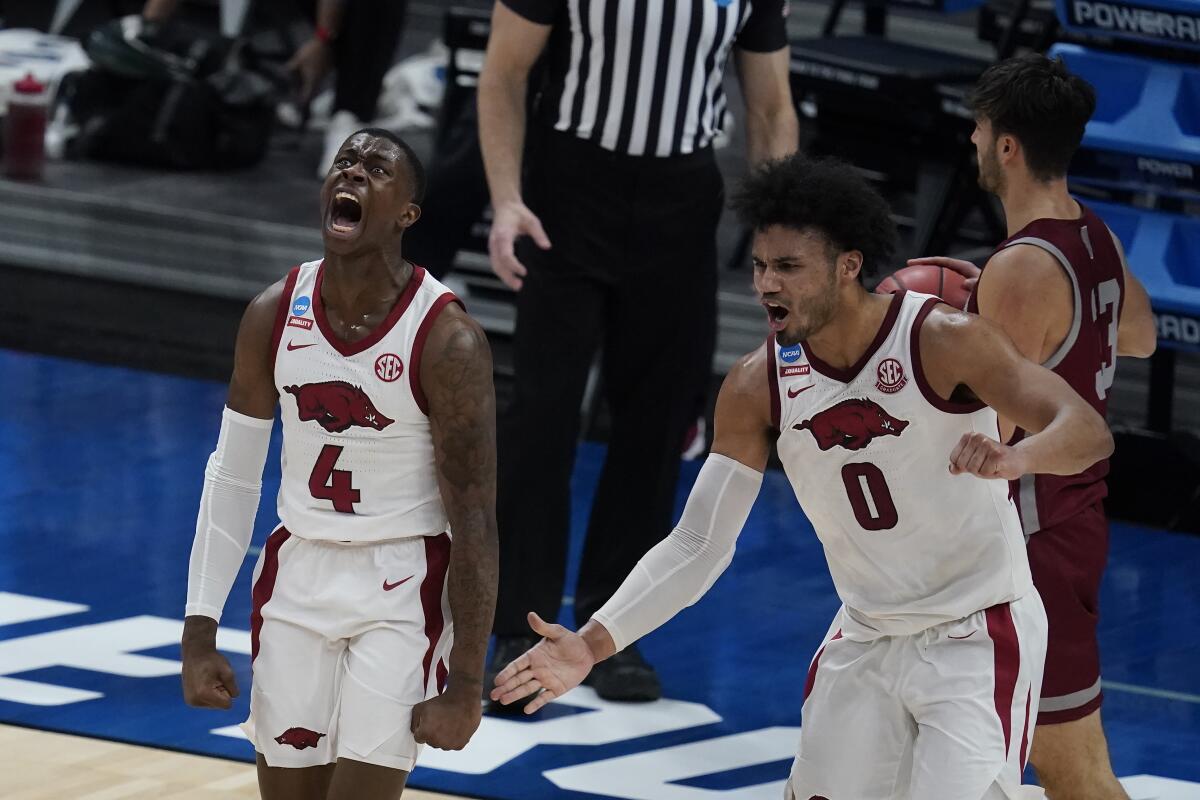 Arkansas' Davonte Davis, left, celebrates with Justin Smith after Davis made a basket as time expired.