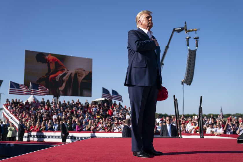 ARCHIVO - El expresidente Donald Trump permanece de pie mientras se interpreta la canción "Justice for All" ("Justicia para todos") durante un mitin de su campaña por la nominación republicana a la presidencia, en el Aeropuerto Regional de Waco, el 25 de marzo de 2023, en Waco, Texas. (AP Foto/Evan Vucci)