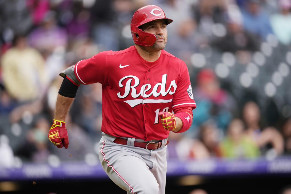 Cincinnati Reds' Joey Votto heads up the first base line as he lines out for the final out in the ninth inning of a baseball game against the Colorado Rockies, Sunday, May 1, 2022, in Denver. (AP Photo/David Zalubowski)