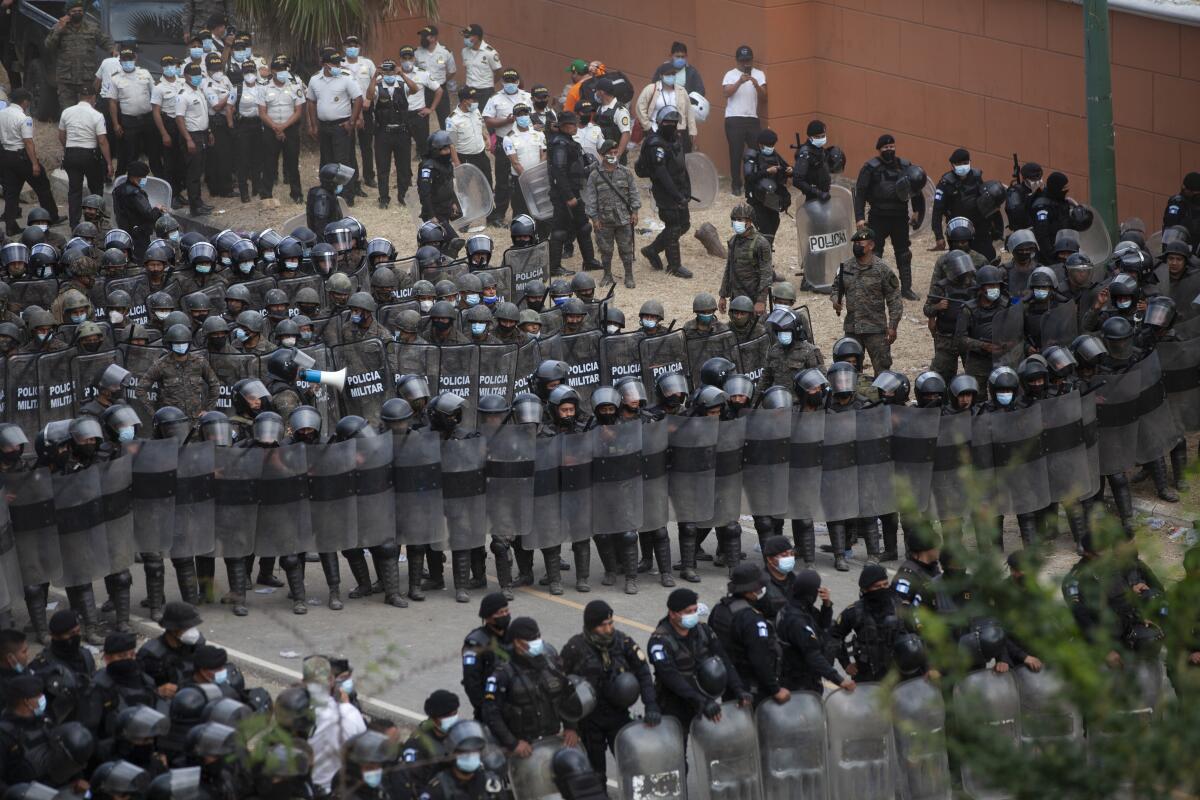 Guatemalan soldiers and police block U.S.-bound Honduran migrants on the highway in Vado Hondo.