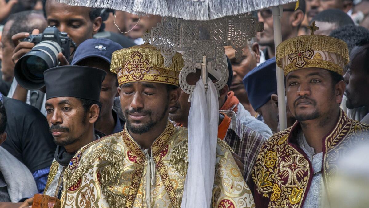 A priest cries at a mass funeral on March 17, 2019, in Addis Ababa, Ethiopia, for crash victims.