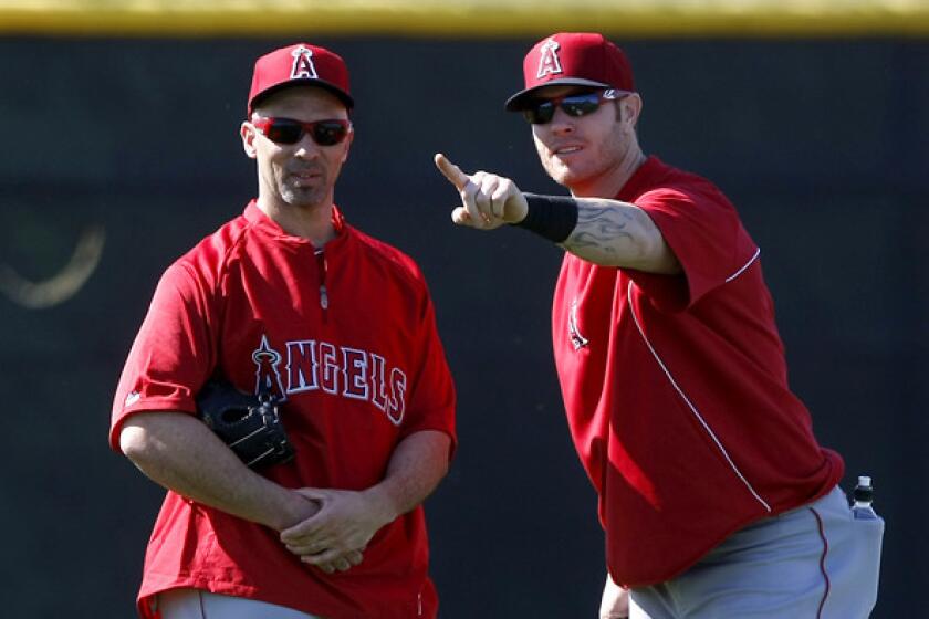 Angels slugger Josh Hamilton, right, shares some thoughts with new teammate Raul Ibanez during a spring workout last week in Tempe, Ariz.