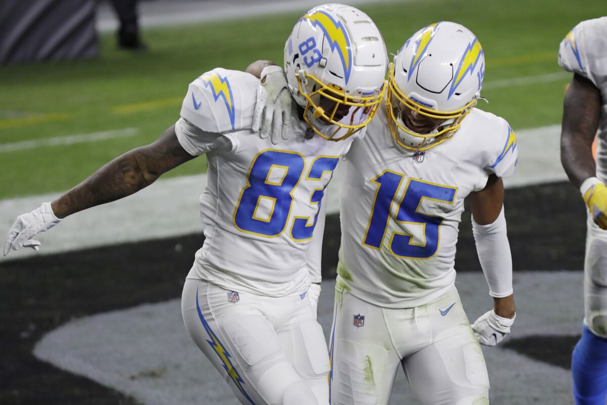 Chargers wide receiver Tyron Johnson, left, celebrates with Jalen Guyton after scoring a first-half touchdown.