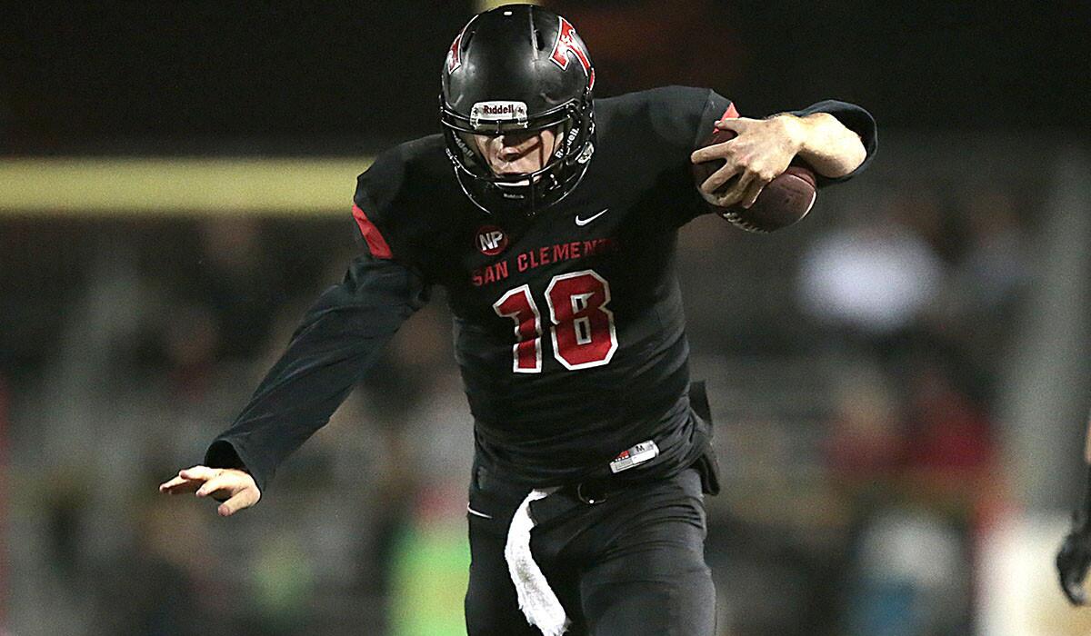 San Clemente quarterback Sam Darnold breaks a tackle during a long run against Trabuco Hills in the Southern Section Southwest Division championship game.