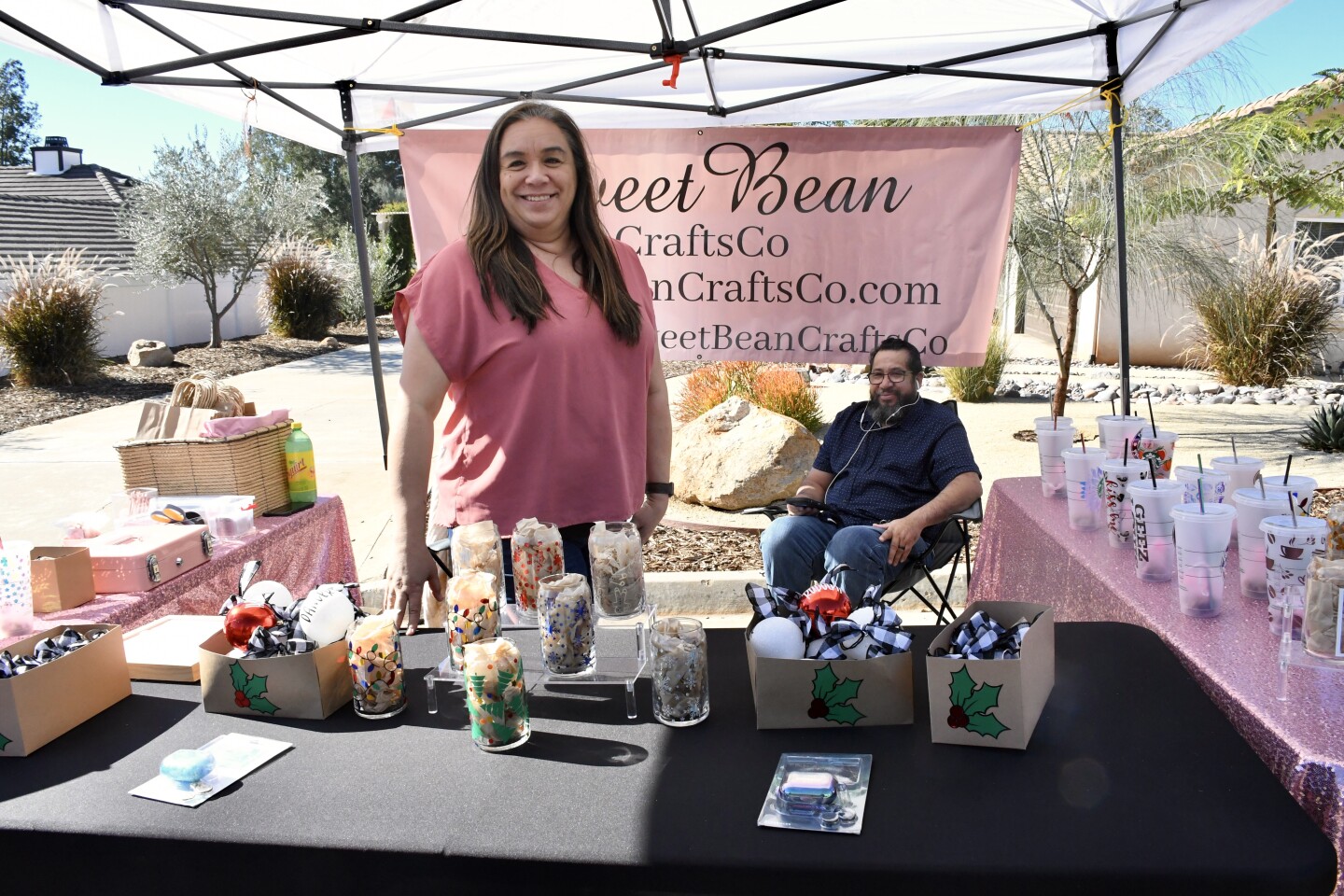 Elizabeth and Martin Mares working their Sweet Bean Crafts booth. They had an assortment of cups and ornaments.
