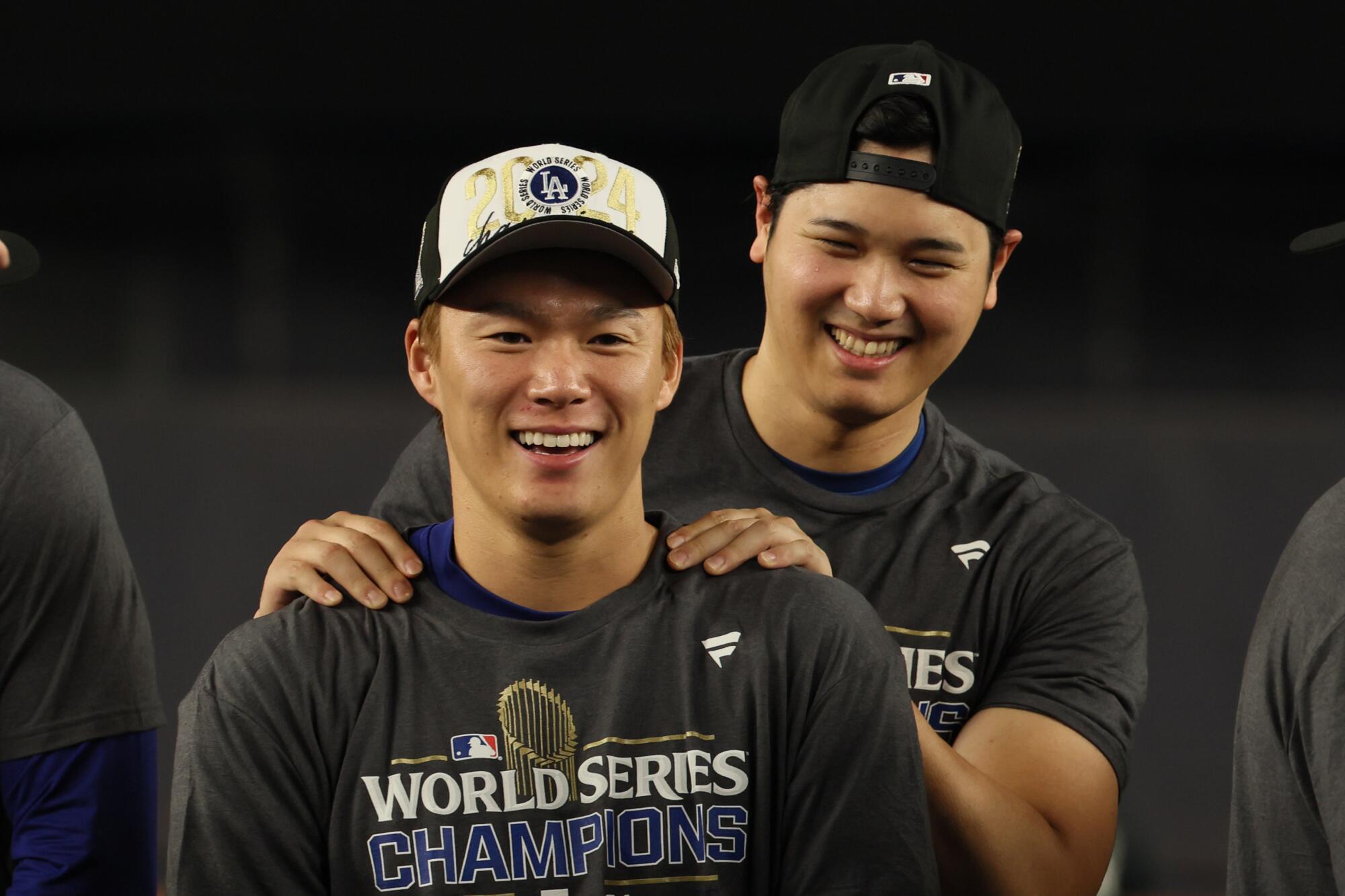Dodgers teammates Shohei Ohtani and Yoshinobu Yamamoto celebrate winning the World Series.