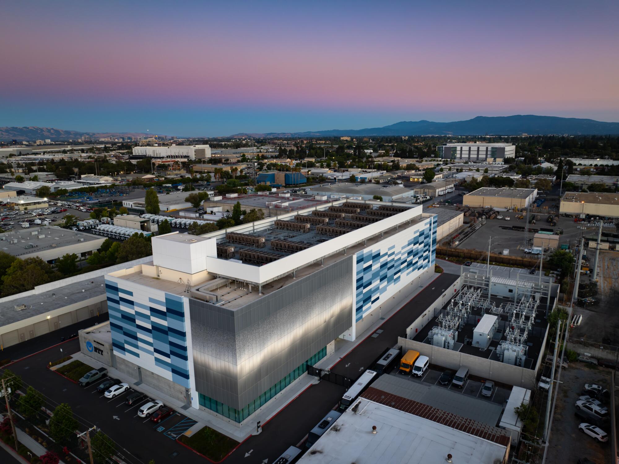 A large data center rises in an urban business district.