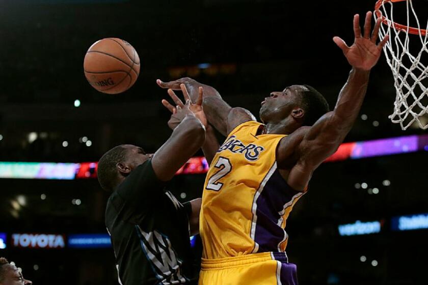 Lakers forward Brandon Bass gets called for a foul on Minnesota forward Gorgui Dieng during a game on Feb. 2.