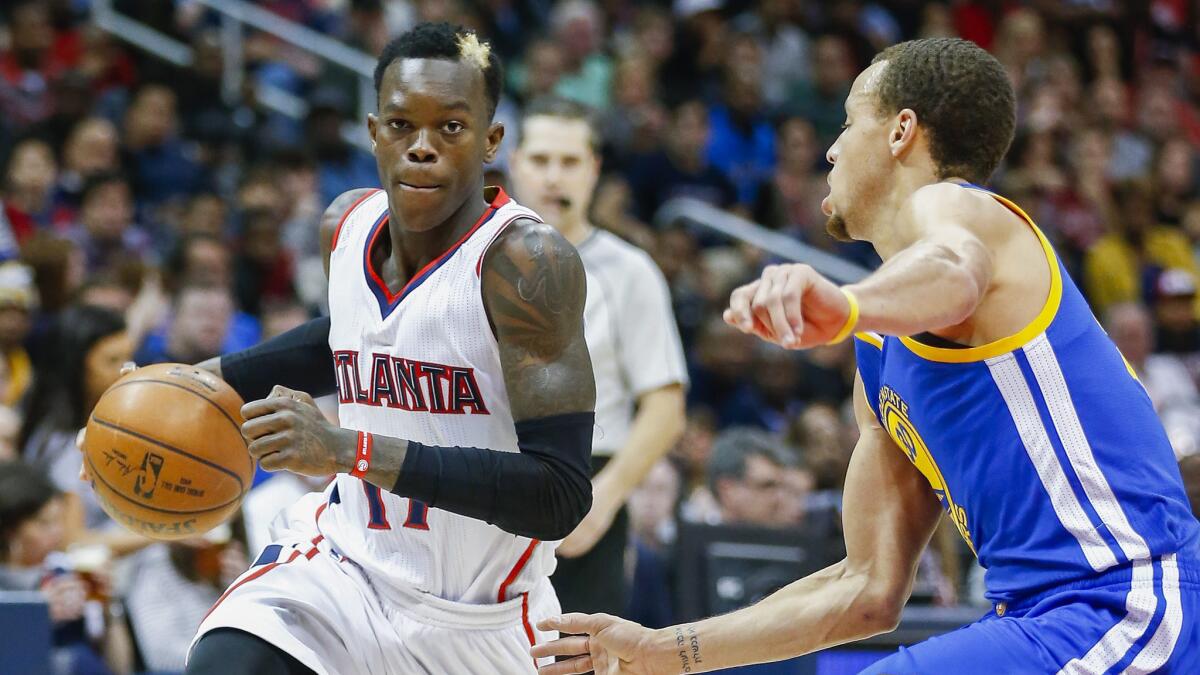 Atlanta Hawks guard Dennis Schroeder, left, drives on Golden State Warriors guard Stephen Curry during the Hawks' 124-116 win Friday.