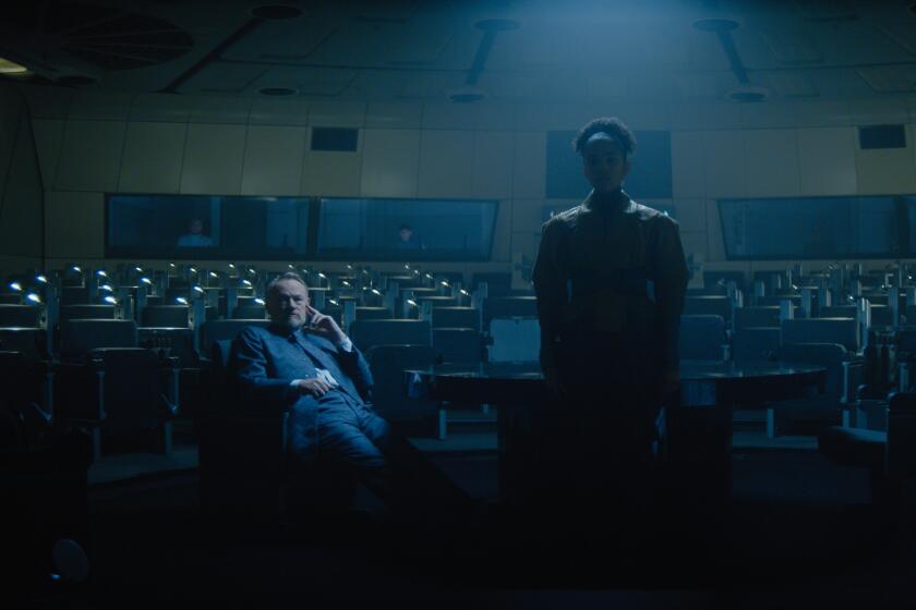 Jared Harris (seated) and Lou Llobel in a scene from Apple TV+'s "Foundation."