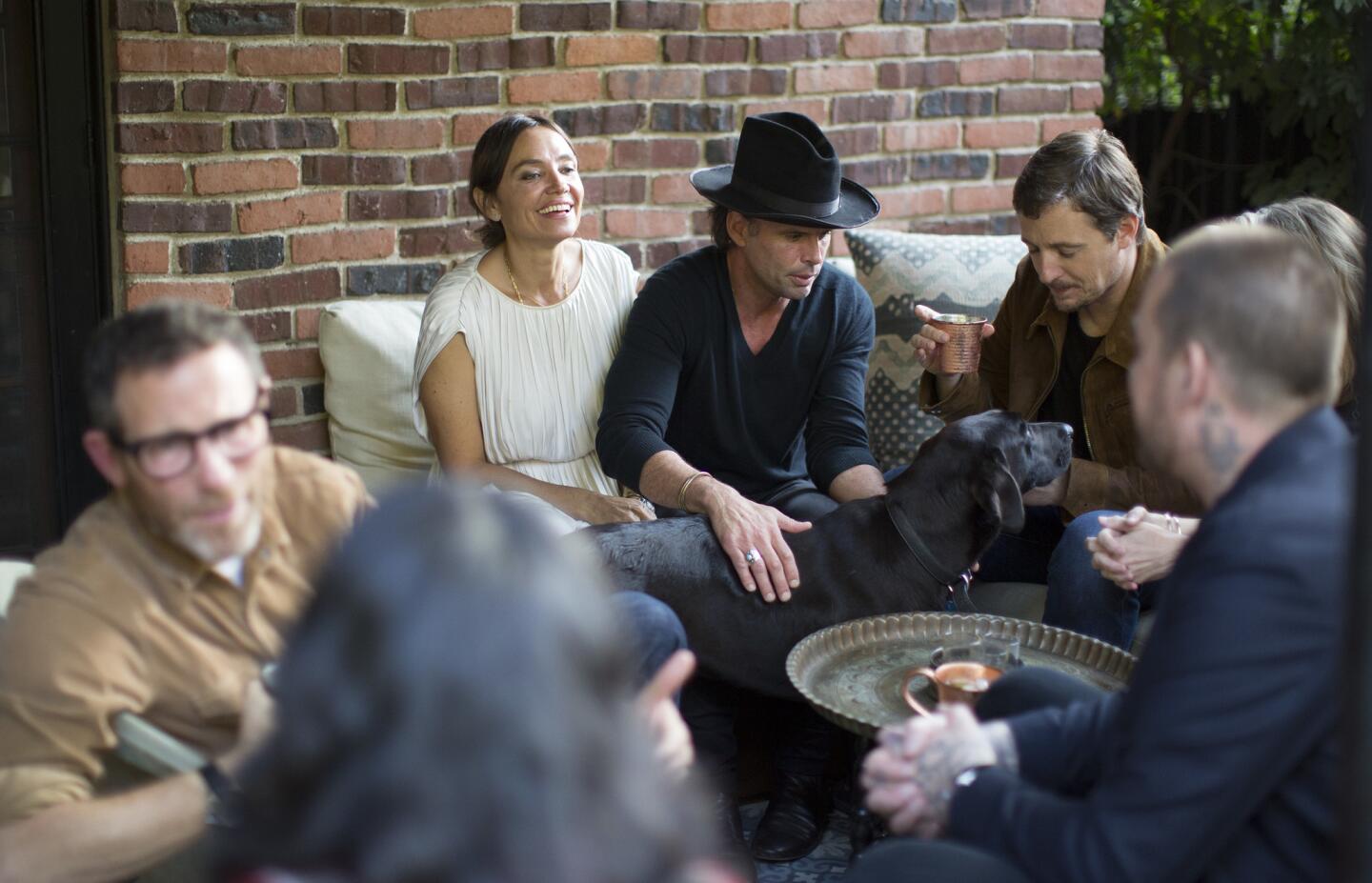 Actor Walton Goggins and wife Nadia Conners, left, entertain guests, including singer-songwriter Sturgill Simpson, right, at their Hollywood home.