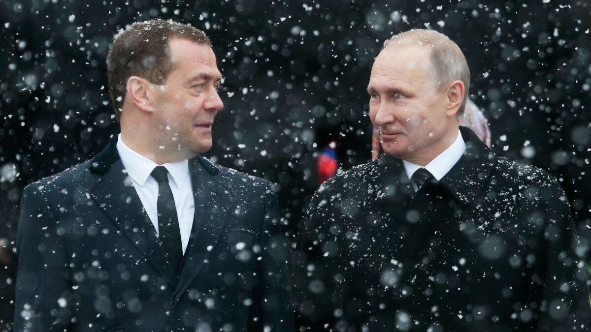 Russian President Vladimir Putin, right, and Prime Minister Dmitry Medvedev attend a wreath-laying ceremony at the Tomb of the Unknown Soldier in Moscow on Feb. 23, 2017. (Ivan Sekretarev / AP)