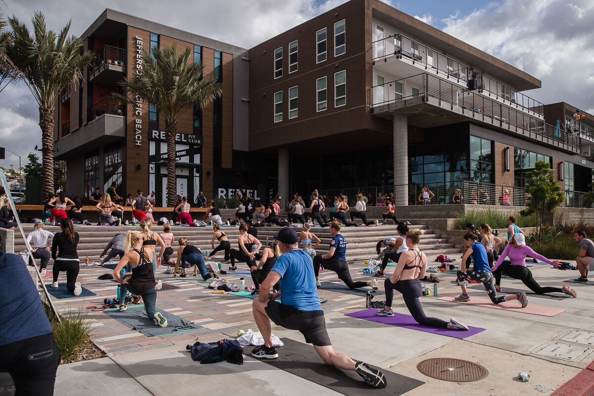 People workout outside of REVEL Fit Club in Pacific Beach on December 31, 2020.