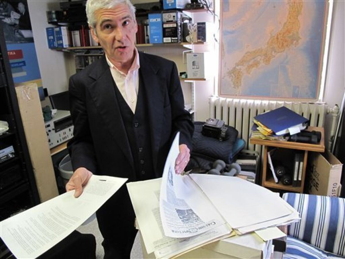 In this Oct. 21, 2011 photo, Joel Sucher goes through a file of documents related to secret New York Police Department program to monitor ethnic groups, student organizations and mosques, at his office in Hastings-on-Hudson, N.Y. (AP Photo/Chris Hawley)