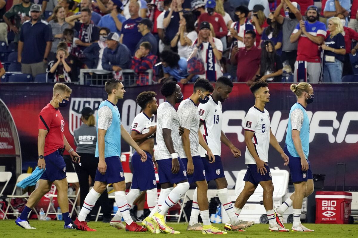 Members of the U.S. soccer team leave the pitch following a 1-1 draw against Canada.