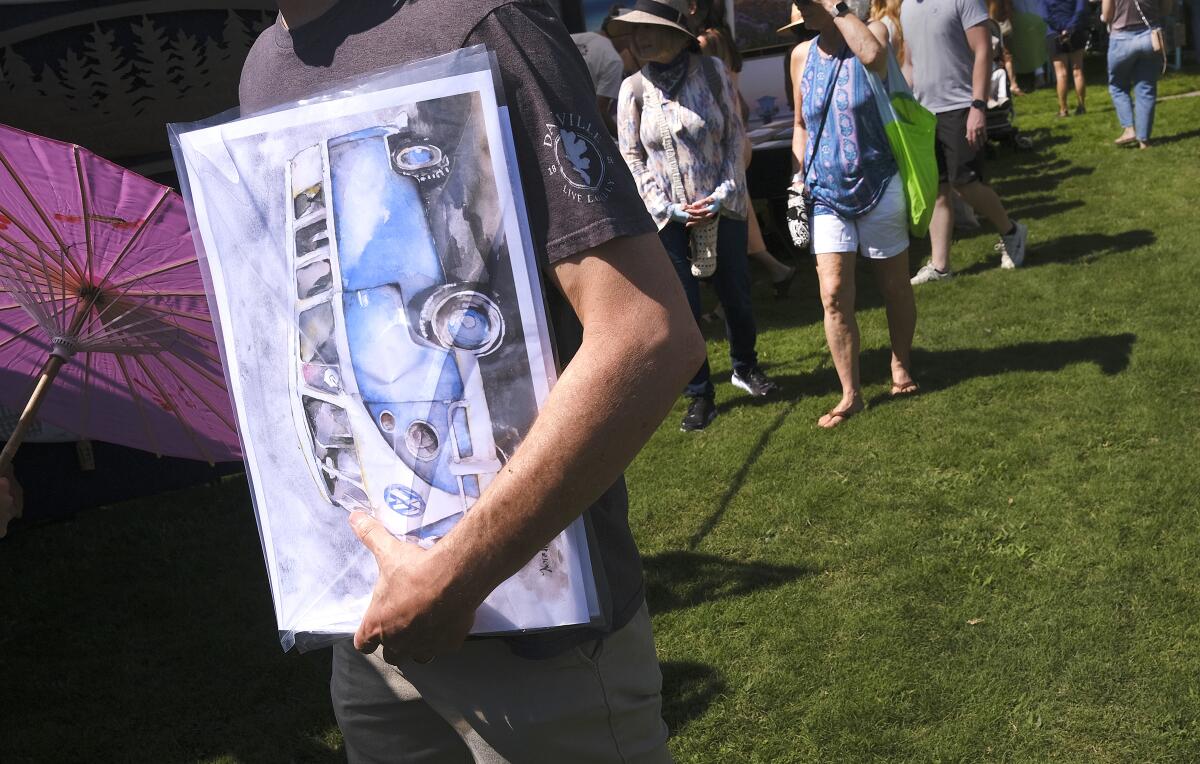 A visitor to LeucadiART Walk on North Coast Highway, walked away with a watercolor painting of a VW micro bus Sunday morning.