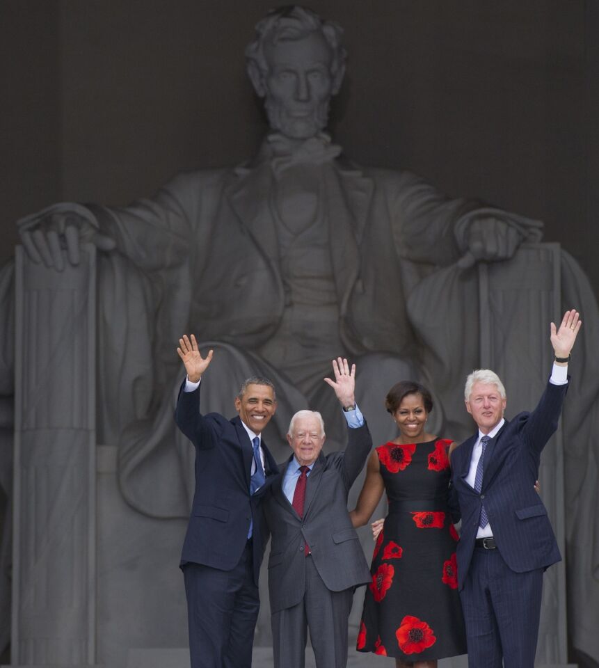 President Obama and First Lady Michelle Obama, along with former presidents Bill Clinton and Jimmy Carter, arrive during the commemoration of the 50th anniversary of the March on Washington.