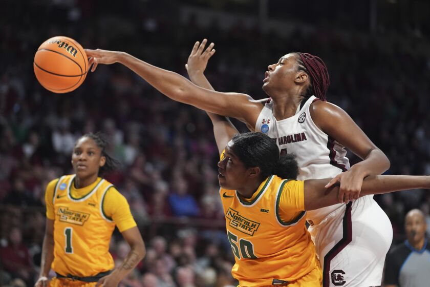 South Carolina forward Aliyah Boston (4) reaches over Norfolk State forward Kierra Wheeler (50) in the first half of a first-round college basketball game in the NCAA Tournament, Friday, March 17, 2023, in Columbia, S.C. (AP Photo/Sean Rayford)