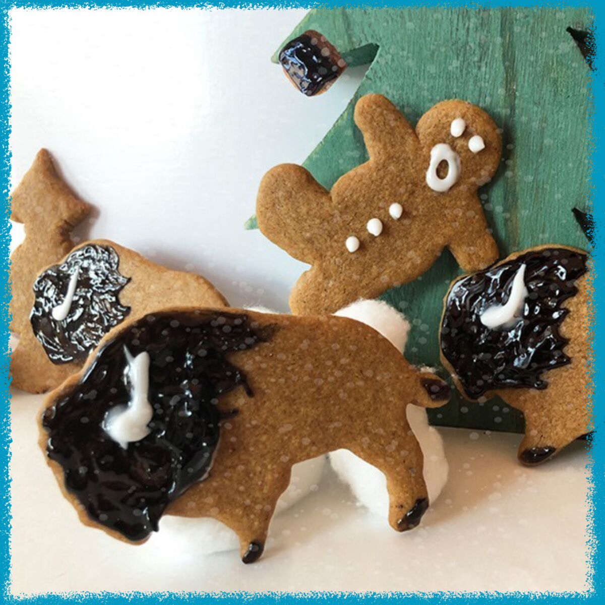 Gingerbread cookies resembling a bison charging a gingerbread man.