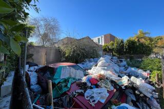 The trash-strewn home of Raymond Daon in the 600 block of North Martel Avenue in Fairfax district of Los Angeles, photographed on April 2, 2024. Neighbors have complained for years about the property, and the city has launched a code enforcement investigation. (Matt Hamilton / Los Angeles Times)