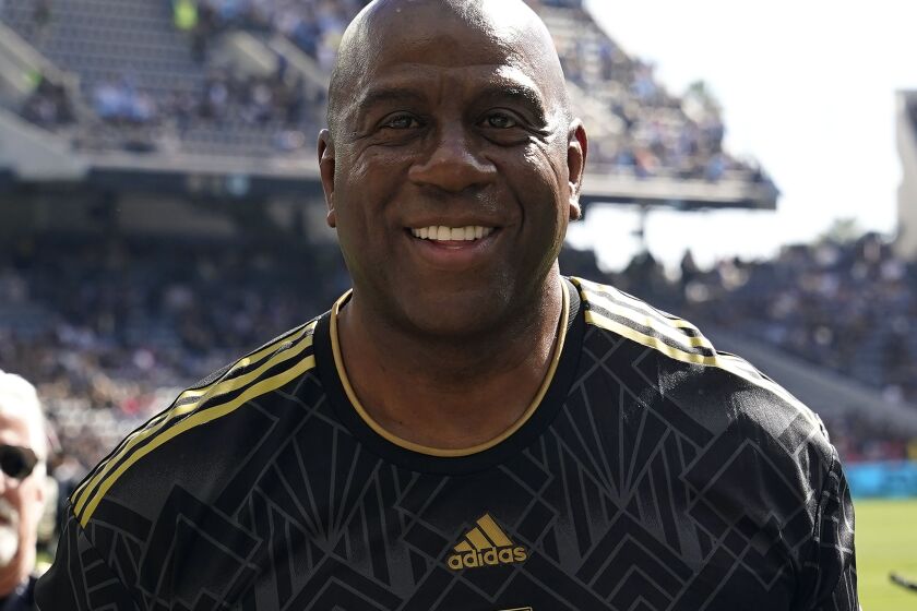 FILE - Former NBA player Magic Johnson smiles before an MLS Cup soccer match Nov. 5, 2022, in Los Angeles. Johnson has joined Josh Harris’ bid to buy the NFL’s Washington Commanders, a person with knowledge of the situation tells The Associated Press. (AP Photo/Marcio Jose Sanchez, File)