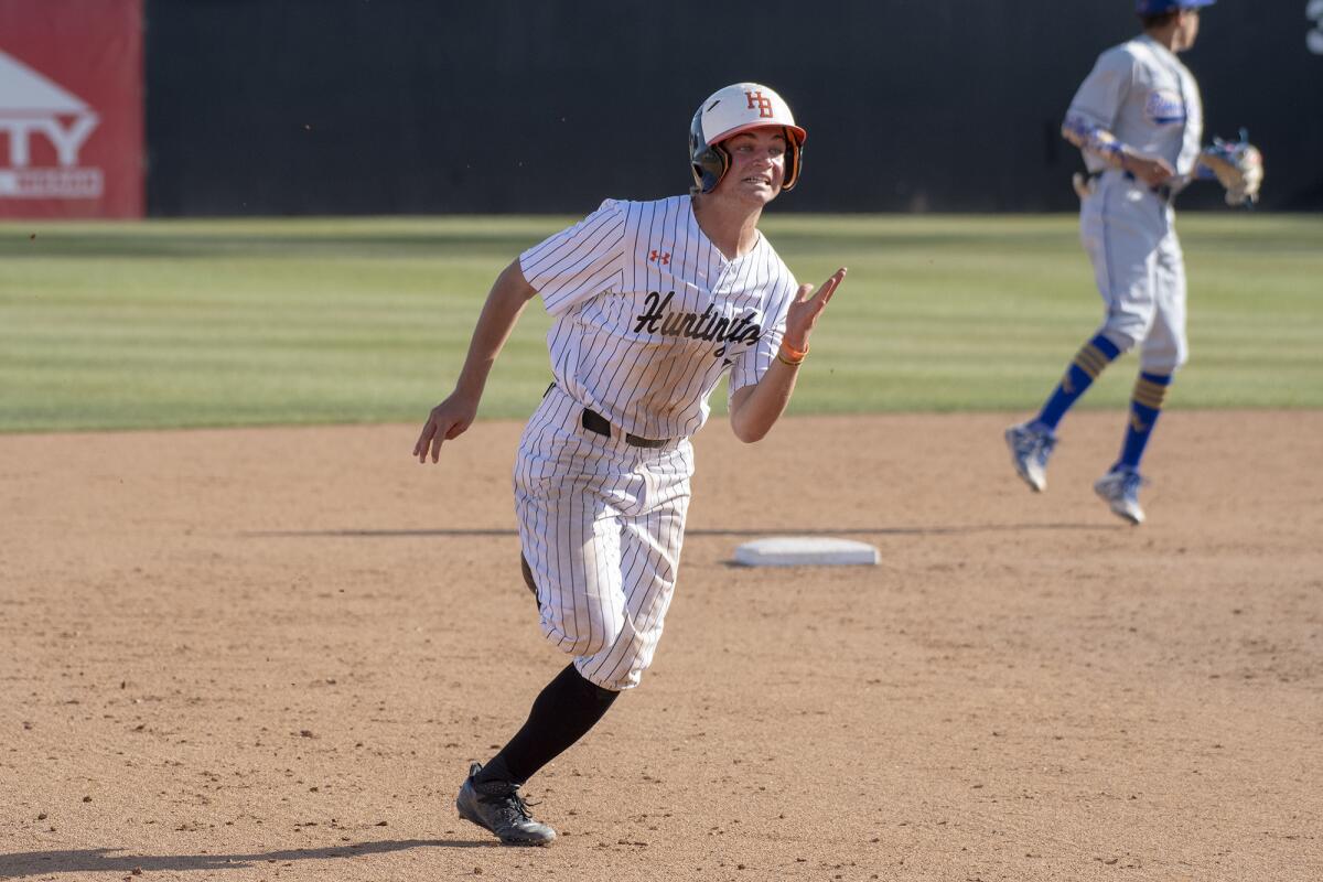 Huntington Beach's Joe Yost, pictured running to third in a May 7, 2019 game against Bishop Amat, helped the Oilers beat Loyola 7-2 on Monday.