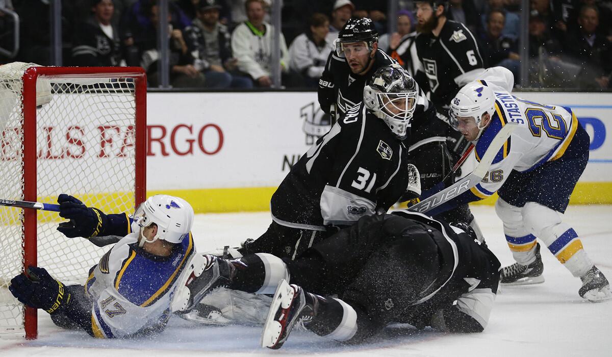 St. Louis Blues forward Jaden Schwartz, left, slides into the net a moment after the puck as teammate Paul Stastny, right, scores past Kings goalie Peter Budaj (31) in the second period at Staples Center on Thursday.