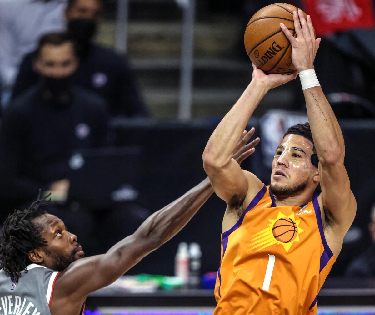 Suns guard Devin Booker shoots over Clippers guard Patrick Beverley during Game 4.