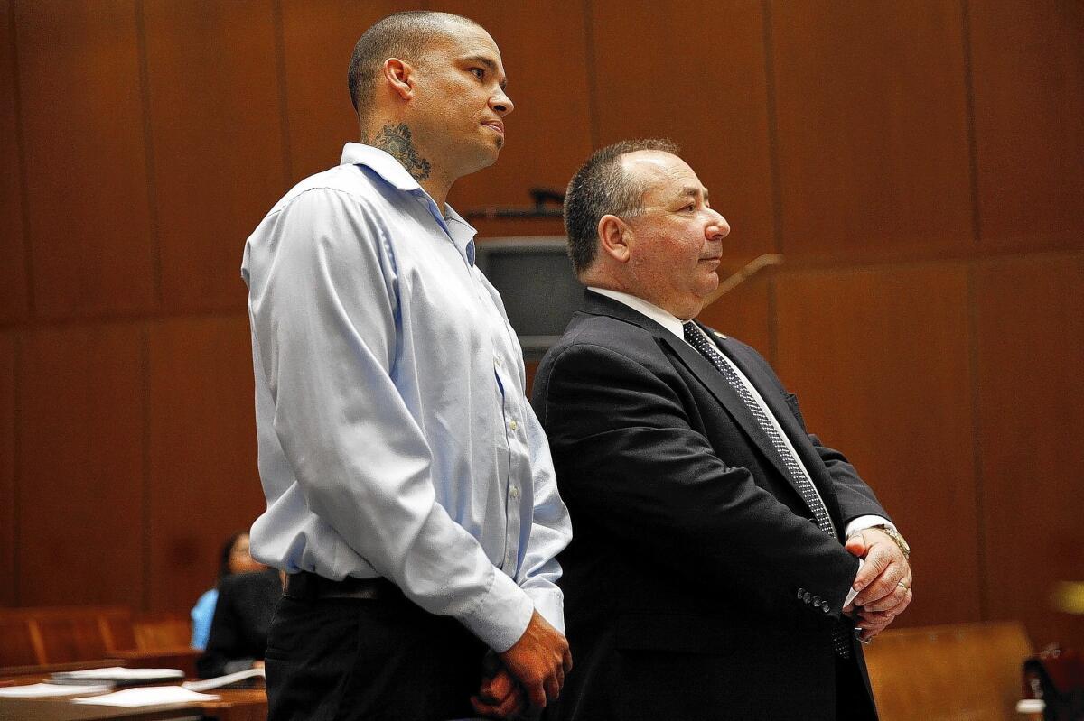 Former Compton Fire Battalion Chief Marcel Melanson, left, appears in Los Angeles County Superior Court with his defense attorney, George F. Bird Jr., on Tuesday. He pleaded no contest to arson and embezzlement charges and is scheduled to be sentenced May 22.