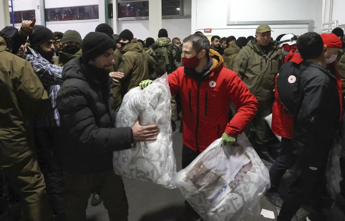 A person hands a big bag to another person.