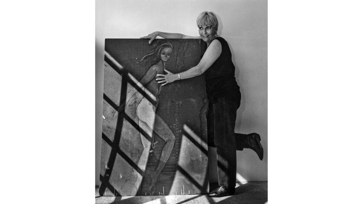 Oct. 10, 1991: The artist poses with a sketch she used as model for the Pink Lady.
