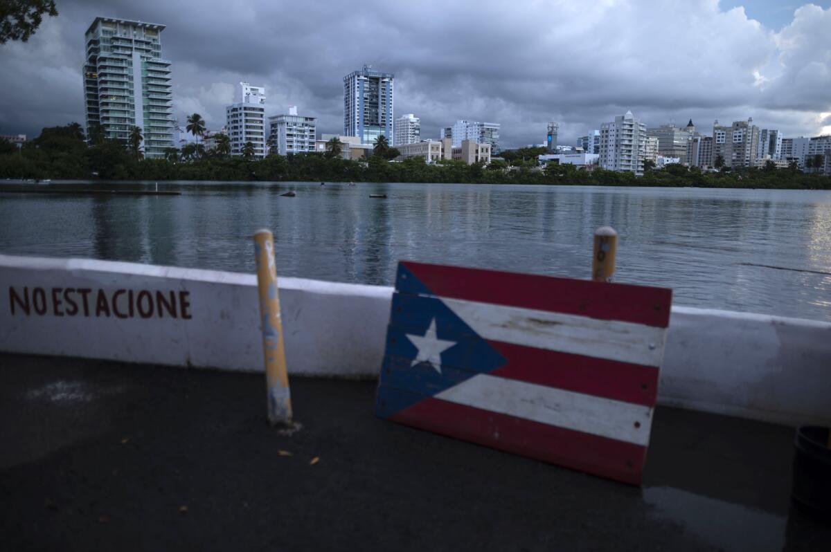 FILE - In this Sept. 30, 2021 file photo, a wooden Puerto Rican flag is displayed on the dock of the Condado lagoon in San Juan, Puerto Rico. The number of people in Puerto Rico who identified as “white” in the 2020 Census plummeted almost 80%, sparking a conversation about identity on an island breaking away from a past where race was not tracked and seldom debated in public. (AP Photo/Carlos Giusti, File)