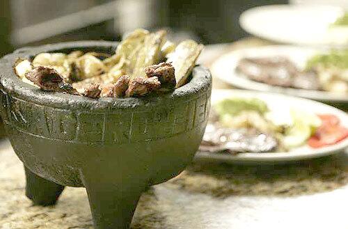 A traditional meal of grilled beef and cactus stew is served at Xalapas Asadero Cien restaurant.