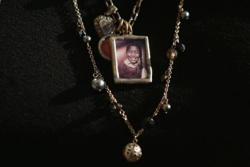 Diane Robertson Braddock wears a necklace with the image of her sister, Carole Robertson, one of four young girls killed in the 1963 16th Street Baptist Church bombing. The children received the Congressional Gold Medals in a ceremony at the U.S. Capitol.