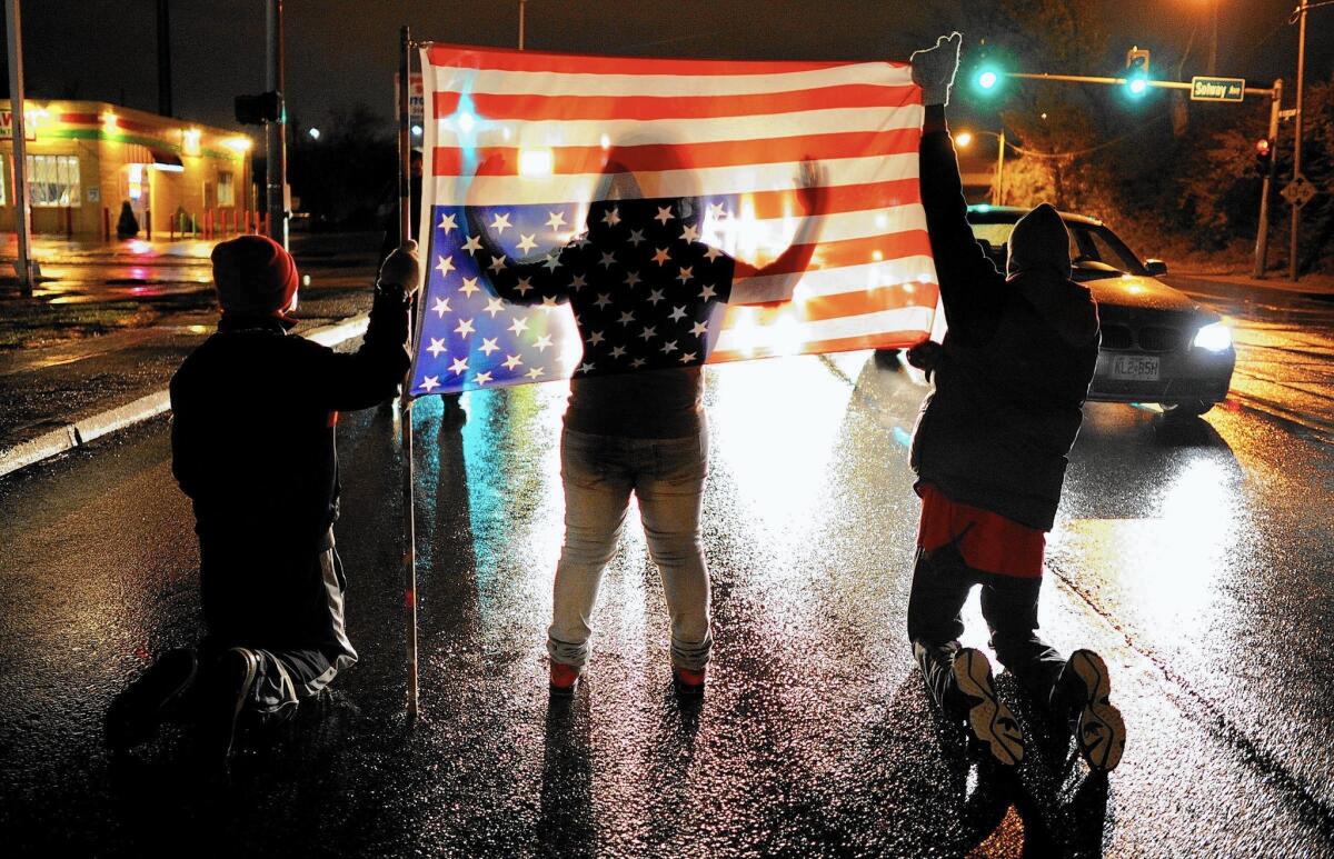Protesters block traffic along West Florissant Avenue in Ferguson, Mo. A grand jury's decision last week not to indict a white Ferguson police officer in the killing of Michael Brown, an unarmed black man, stoked anger over the shooting, leading to more demonstrations and arrests.