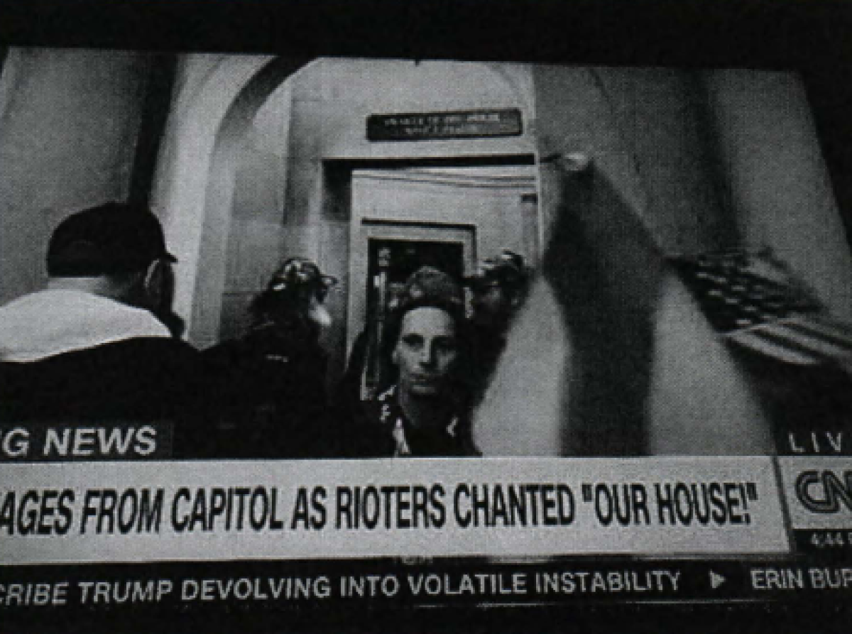A man among a crowd in the Capitol in a screengrab from CNN.