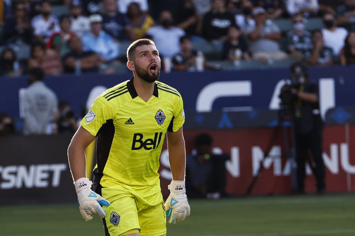 Former Whitecaps goalkeeper Maxime Crépeau (16) looks up the field during a 2021 match against the Galaxy.