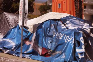 LOS ANGELES, CA - SEPTEMBER 25, 2023 - MIRAGE - A homeless person used a street advertisement billboard, featuring a man in a swimming pool, as part of his tent in downtown Los Angeles on September 25, 2023. (Genaro Molina / Los Angeles Times)